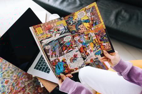person-reading-comic-book-at-home-in-living-room-