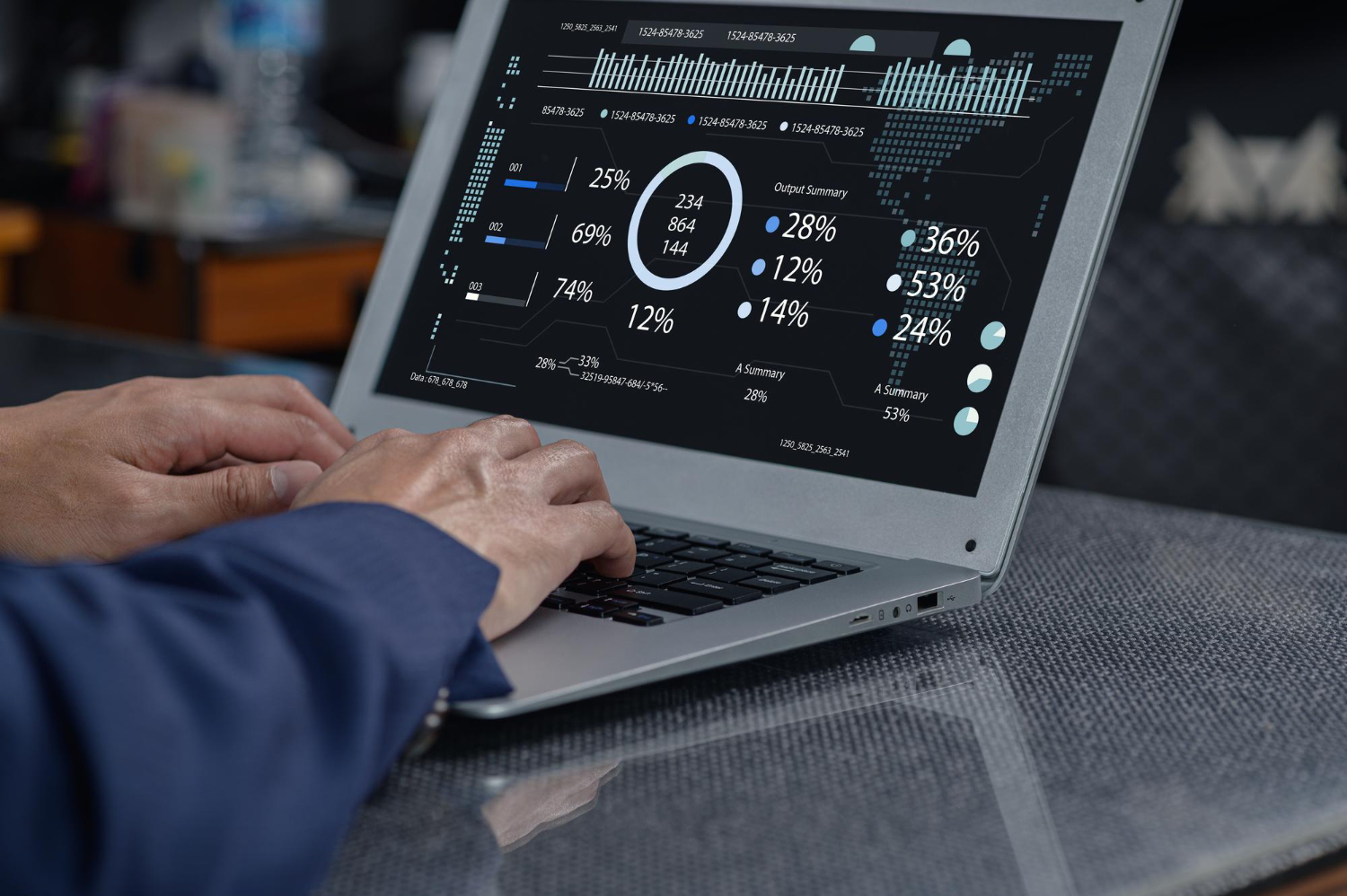 Hands typing on a laptop computer